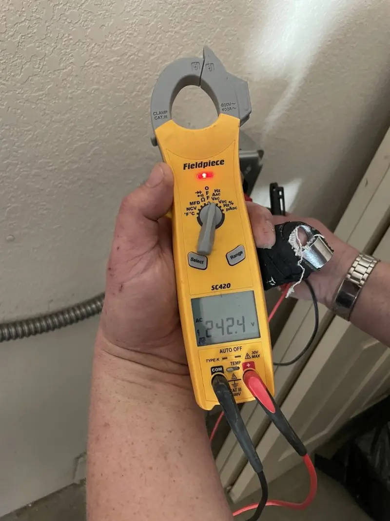 Voltage testing with clamp meter during Outlet Installation in Manassas
